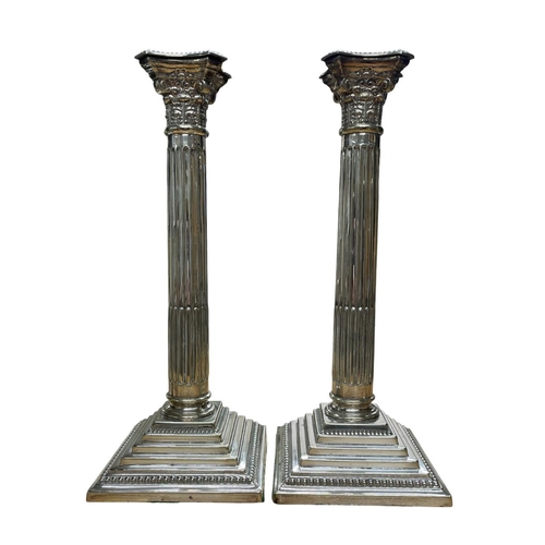 139 - Pair of silver plated Corinthian column stepped base candlesticks, H 32cm