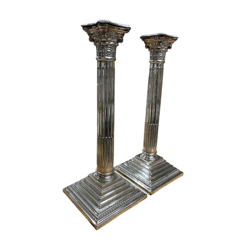 139 - Pair of silver plated Corinthian column stepped base candlesticks, H 32cm