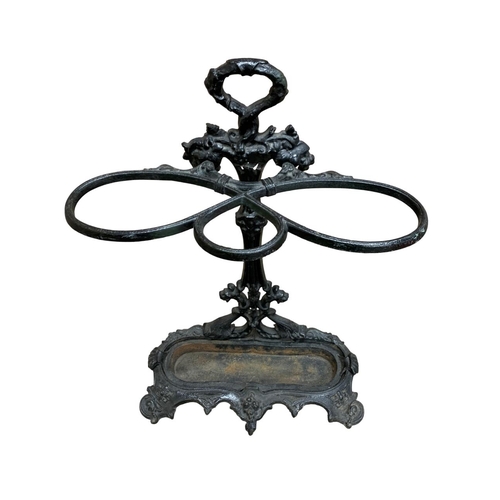 555 - Victorian coalbrookdale black painted cast iron stick stand with scrolling and leaf detail, complete... 