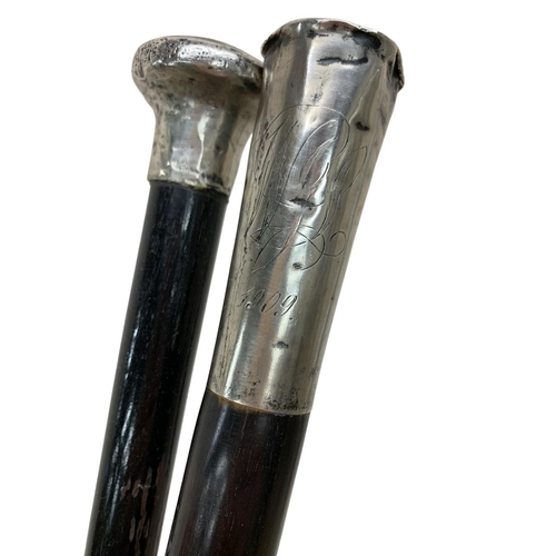 675 - Early 20th century silver mounted walking stick dated 1909, together with a further ebonised walking... 