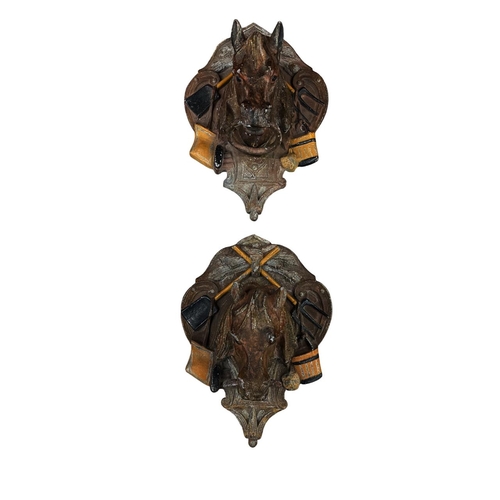 622 - Pair of French cast iron wall mounting stable horse tethers modelled as horse heads and saddles, cir... 