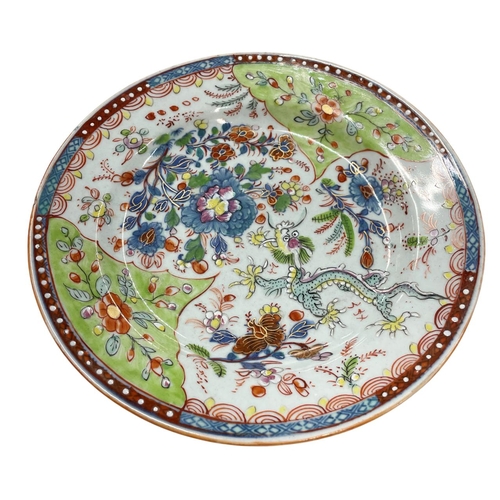 352 - 18th Century Chinese famile rose 'clobbered' plate depicting a dragon amongst flowers, signed to bas... 