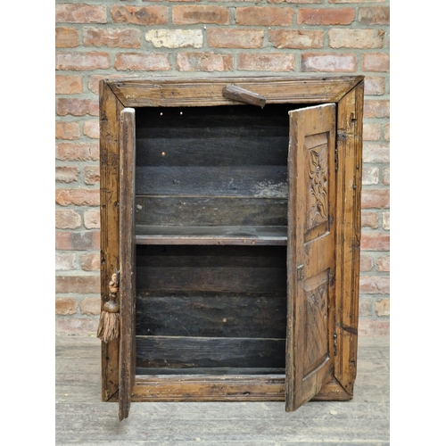 1382 - 18th century rustic cabinet with carved fielded panels and twin cupboard doors revealing a shelved i... 