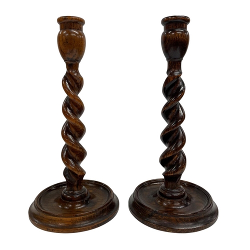 1073 - Three oak barley twist table lamps with associated shades, together with a pair of barley twist cand... 