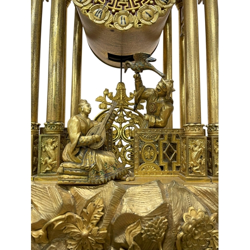 215 - After Theodore Leroy (1788-1839) - A Chinese style gilt metal portico clock in the form of a pagoda,... 