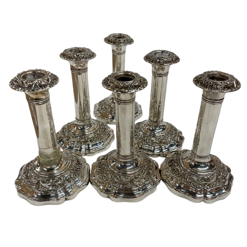 141 - Set of six silver plated Regency candlesticks, having ornate scrolled decoration to base and fluted ... 