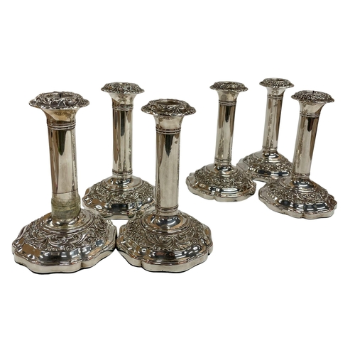 141 - Set of six silver plated Regency candlesticks, having ornate scrolled decoration to base and fluted ... 