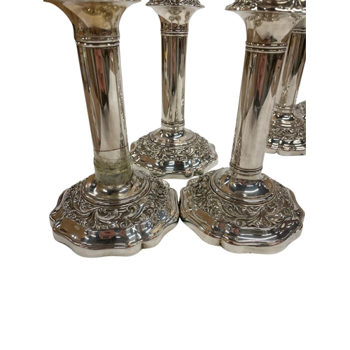 141 - Set of six silver plated Regency candlesticks, having ornate scrolled decoration to base and fluted ... 