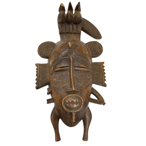 317 - Mixed tribal lot to include animal hide shield, carved wood Senufo tribe mask with a further primiti... 