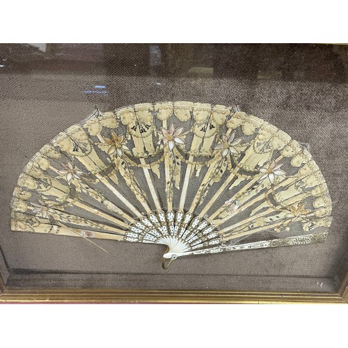 634 - Regency fan with embroidered floral decoration and sequin garlands on laced ground, the montures wit... 