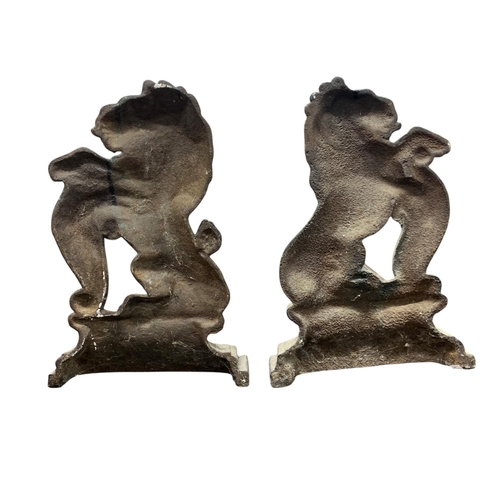 523 - Pair of 19th century cast iron door porters modelled as opposing rampant lions, each 37cm high (2)