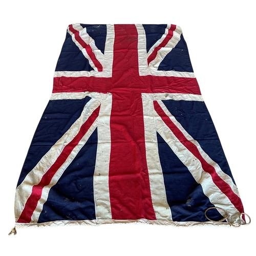 597 - Quantity of very large Union Jack stitched canvas flags, possibly maritime, having original wooden t... 