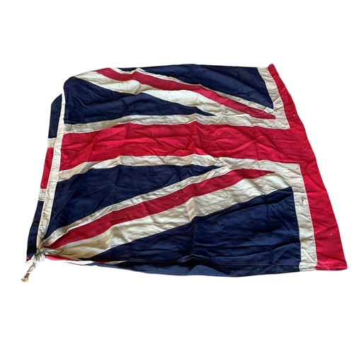 597 - Quantity of very large Union Jack stitched canvas flags, possibly maritime, having original wooden t... 