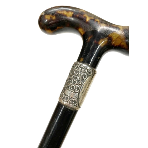 647 - Hardwood walking cane with pressed tortoiseshell tau-shaped handle, having a silver collar with mono... 