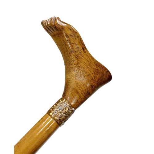 648 - Folk Art composite walking cane with hardwood handle carved as a foot, having ornate scrolled copper... 