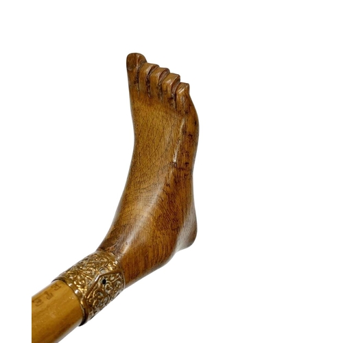 648 - Folk Art composite walking cane with hardwood handle carved as a foot, having ornate scrolled copper... 