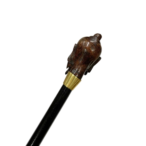 655 - Stained hardwood walking cane with hardwood handle carved as an Asian sage's head, having an 18ct go... 