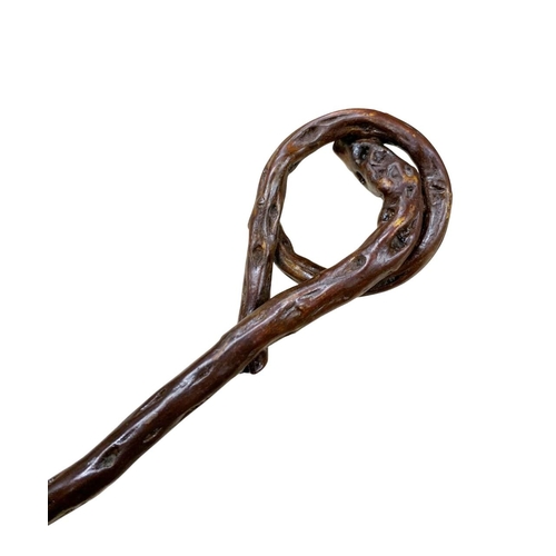 657 - Crude Folk Art walking stick of curled river wood, having three white metal metal inlays to handle a... 