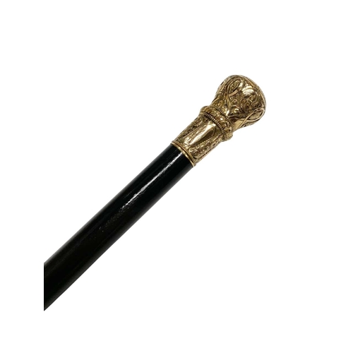 673 - Ebonised hardwood walking cane with gilt embossed and chased metal handle, L 89cm