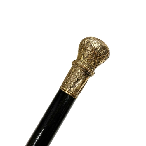 673 - Ebonised hardwood walking cane with gilt embossed and chased metal handle, L 89cm