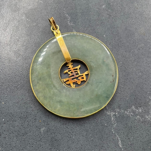 56 - Chinese jade disc pendant with 14ct mounts, 4.8cm diameter. 16.5g gross.