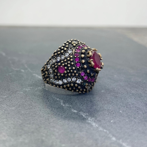 47 - Eccentric Indian silver, red and colourless paste cocktail type ring, central ruby 1ct approx, size ... 