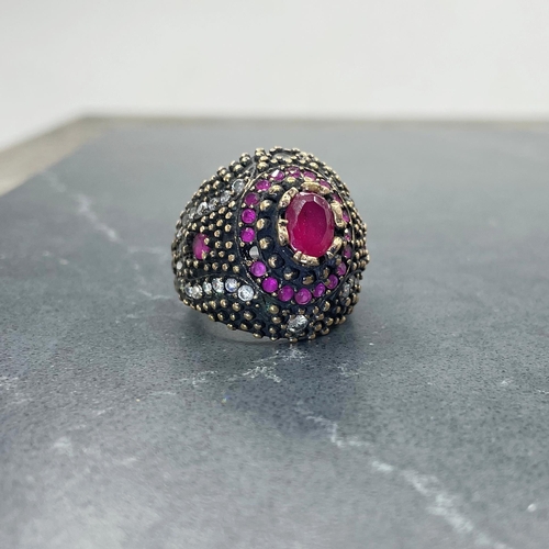 47 - Eccentric Indian silver, red and colourless paste cocktail type ring, central ruby 1ct approx, size ... 
