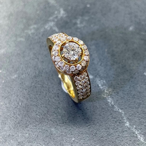 54 - Impressive '750' and diamond halo ring, central stone .5ct, framed by smaller diamonds with further ... 