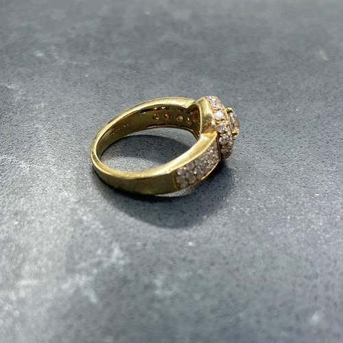 54 - Impressive '750' and diamond halo ring, central stone .5ct, framed by smaller diamonds with further ... 