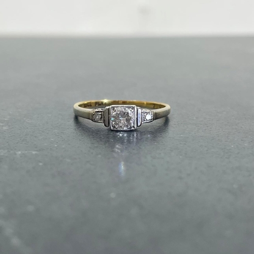 66 - 18ct and platinum diamond ring, .30ct central stone flanked by two smaller diamonds, size K, 1.8g