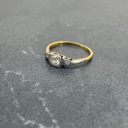 66 - 18ct and platinum diamond ring, .30ct central stone flanked by two smaller diamonds, size K, 1.8g
