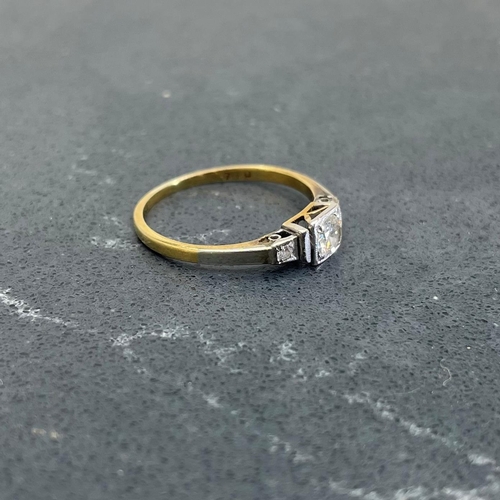 66 - 18ct and platinum diamond ring, .30ct central stone flanked by two smaller diamonds, size K, 1.8g