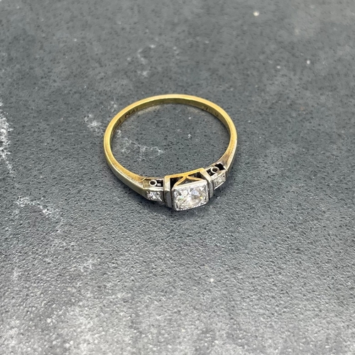 66 - 18ct and platinum diamond ring, .30ct central stone flanked by two smaller diamonds, size K, 1.8g