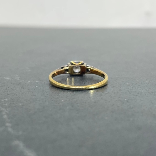 66 - 18ct and platinum diamond ring, .30ct central stone flanked by two smaller diamonds, size K, 1.8g