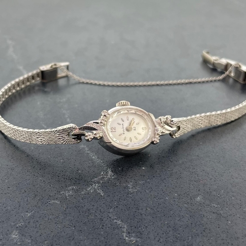 4 - Bulova 14k white gold ladies cocktail watch, 16mm case with fancy diamond set bezel, silvered dial w... 