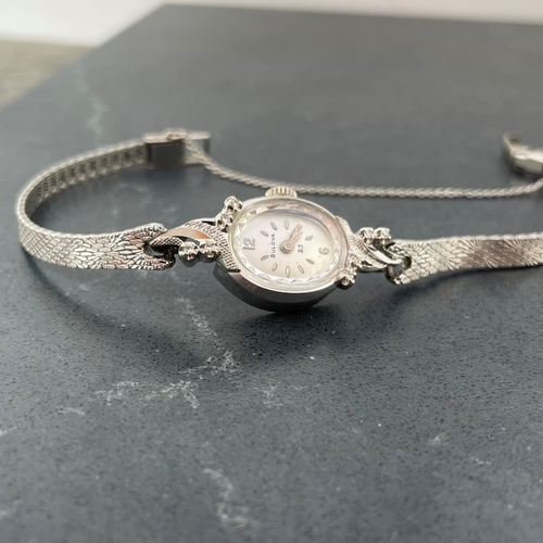 4 - Bulova 14k white gold ladies cocktail watch, 16mm case with fancy diamond set bezel, silvered dial w... 
