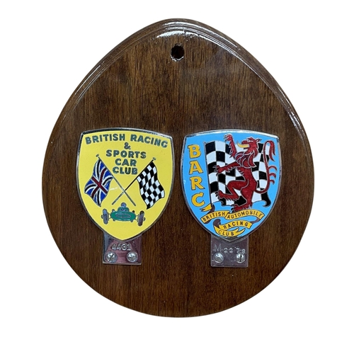49 - British Racing & Sports Car Club and a B.A.R.C enamel car badge, mounted atop wooden shield display ... 