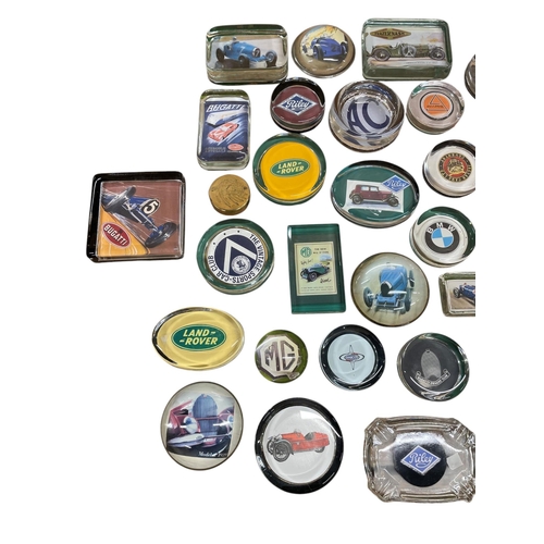 61 - An extensive collection of automobilia car related glass paperweights to include Bugatti, Land Rover... 