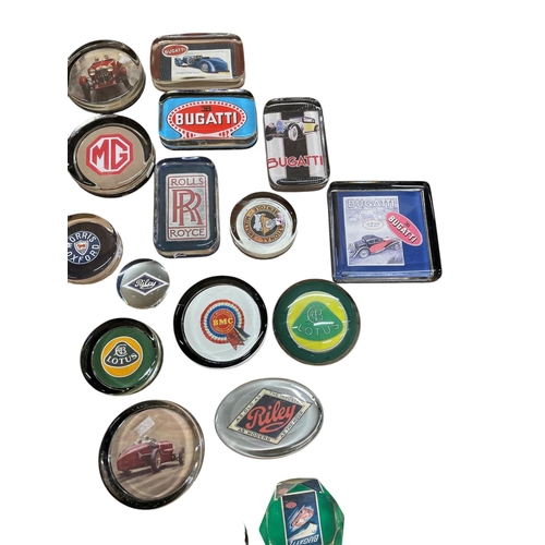 61 - An extensive collection of automobilia car related glass paperweights to include Bugatti, Land Rover... 