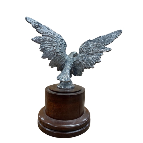 14 - Car mascot - Eagle, with spread wings, on associated mahogany plinth, 21cm high in total