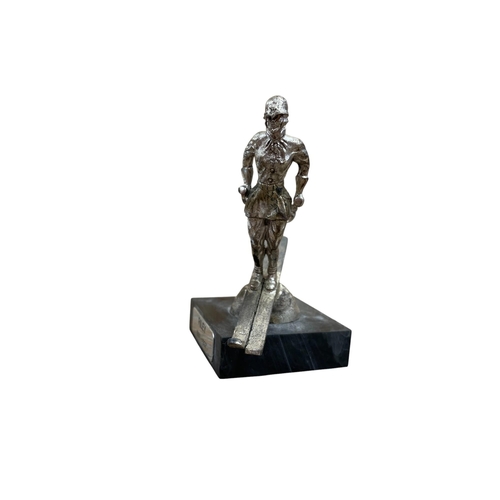 11 - Car mascot - The Riley Skier, chromed cast metal, plastic plinth with inscription, 9.5cm in total