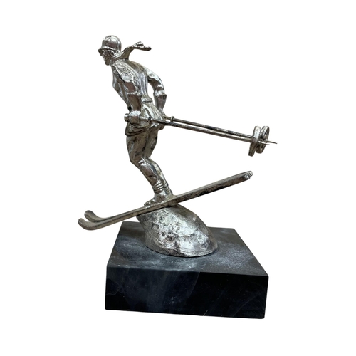 11 - Car mascot - The Riley Skier, chromed cast metal, plastic plinth with inscription, 9.5cm in total