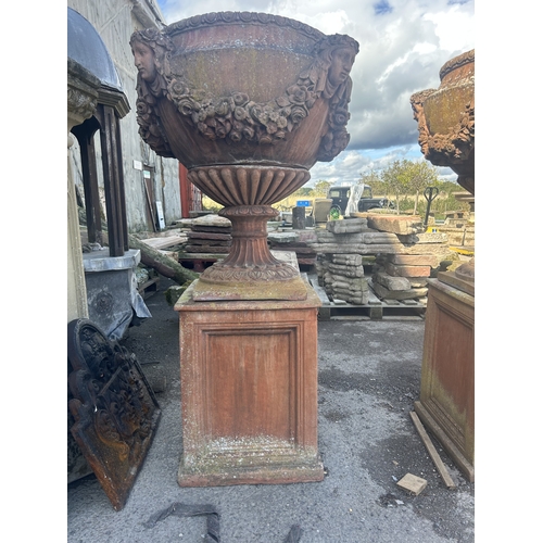 236 - Good quality pair of terracotta urns with classical maiden mask detail, floral swags and darted rims... 