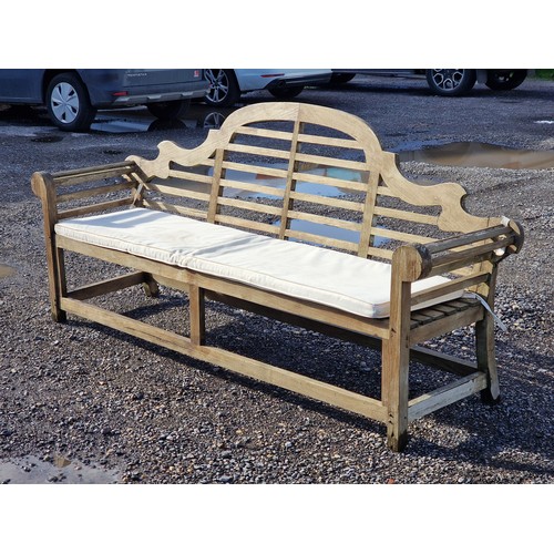 101 - Large four seat teak Lutyens style bench with cushion, H 104cm x W 225cm x D 50cm