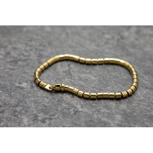 47 - A vintage Italian gold tubular-link bracelet on a trigger clasp, the end-link marked 'TREEMME', the ... 