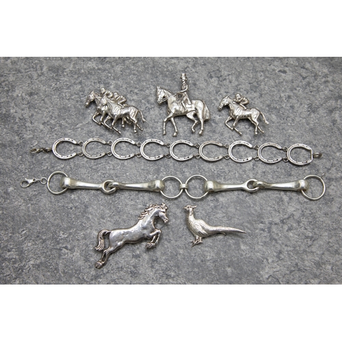 67 - A group of silver equestrian jewellery and a pheasant brooch, Comprising; a jumping pony; two race h... 