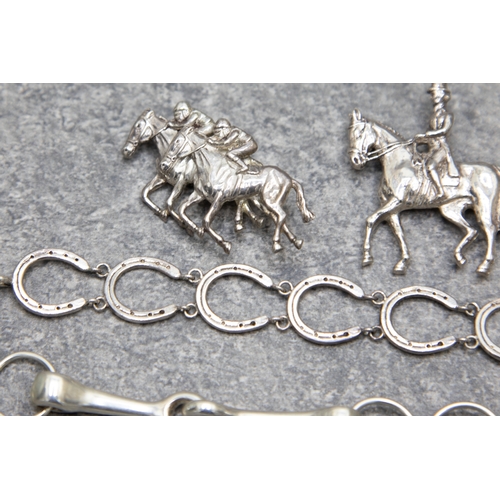 67 - A group of silver equestrian jewellery and a pheasant brooch, Comprising; a jumping pony; two race h... 