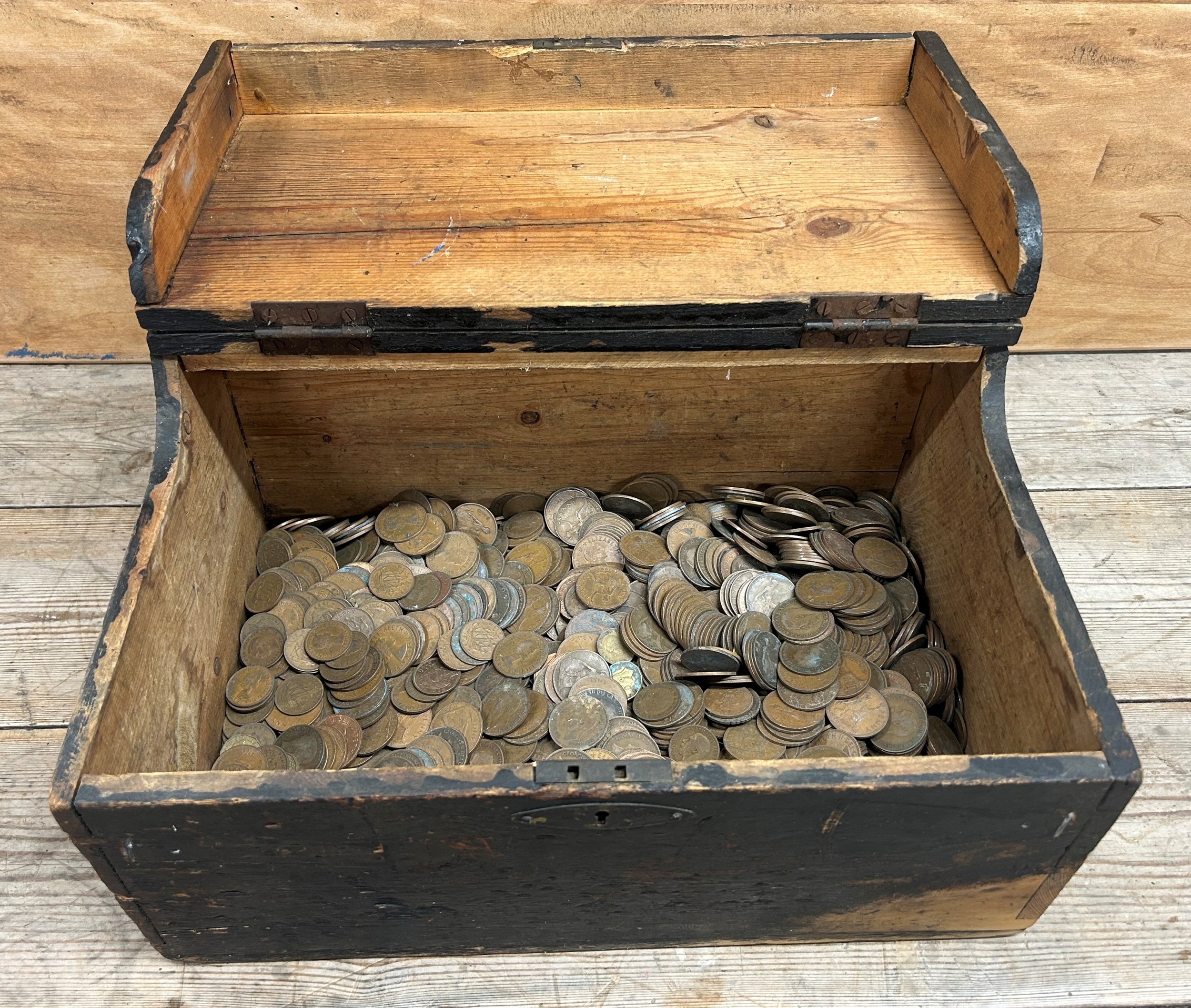 Antique wooden chest with a large quantity of coins to include ...