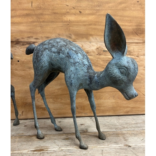 325 - Two cast bronze garden ornament sculptures of deer, largest H 55cm