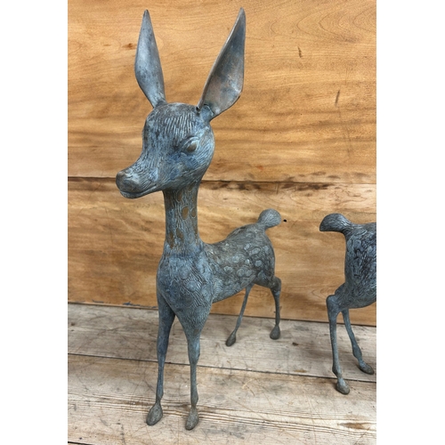 325 - Two cast bronze garden ornament sculptures of deer, largest H 55cm